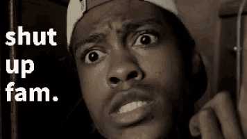 a close up of a man 's face with the words `` shut up fam . ''
