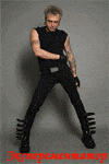 a man in a black tank top and black pants is standing in front of a gray background