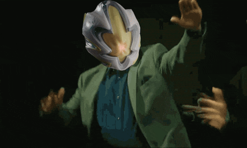 a person is holding a helmet that looks like a shield with a light coming out of it