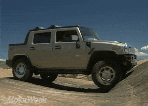 a hummer truck is parked on a dirt road with motorweek written on the bottom right