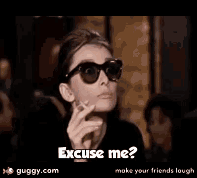 a woman wearing sunglasses and a cigarette says excuse me ?