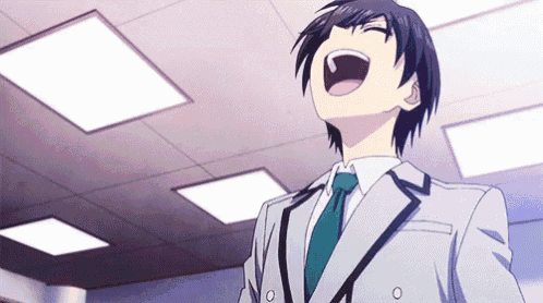 a man in a suit and tie is laughing with his mouth open in a room .