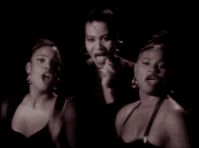 a group of three women are standing next to each other
