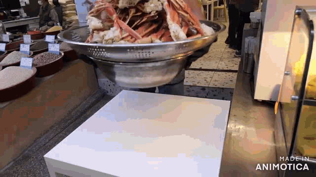 a large bowl of food is on a table with the words made in animotica on the bottom right