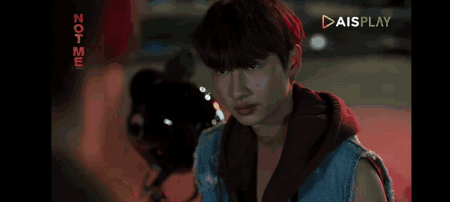 a screenshot of aisplay shows a young man in a red hoodie