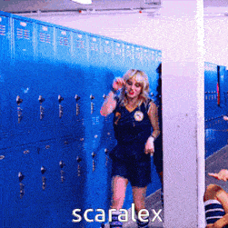 a woman in a locker room with scaralex written in white