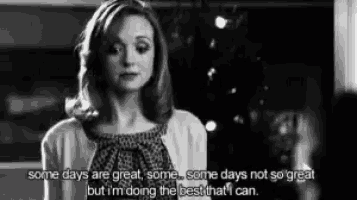 a woman is standing in front of a christmas tree with a quote .