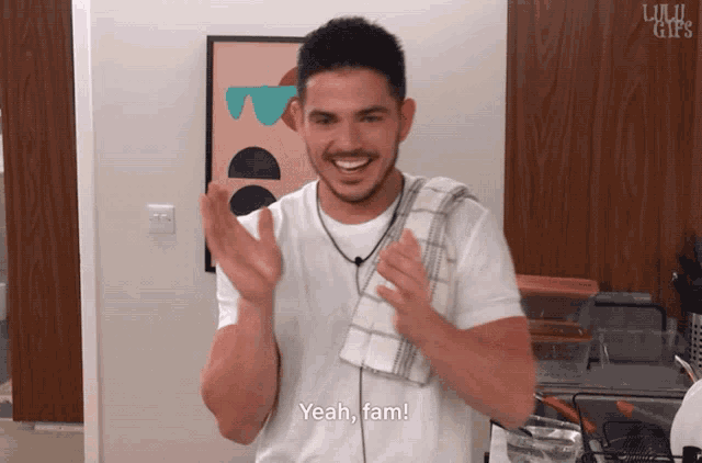 a man wearing a white shirt and a towel around his neck says yeah fam