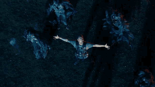 a man with his arms outstretched surrounded by monsters