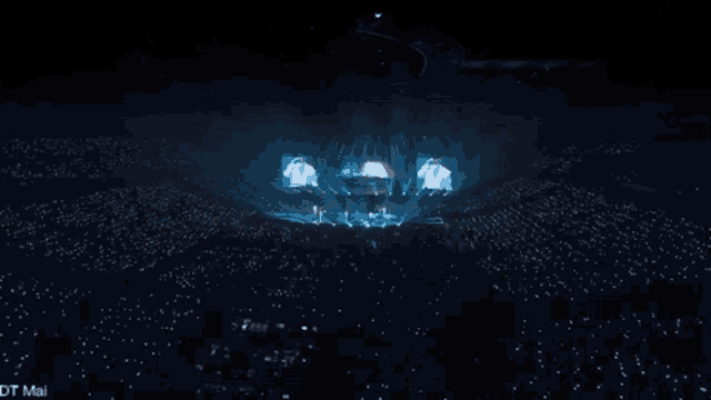 a crowd of people are watching a concert and the words dt mai are on the bottom