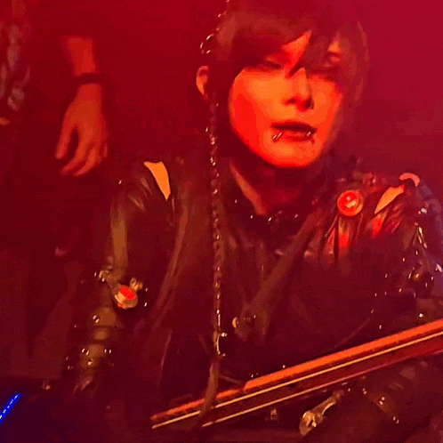 a woman with a piercing in her lip is playing a drum set