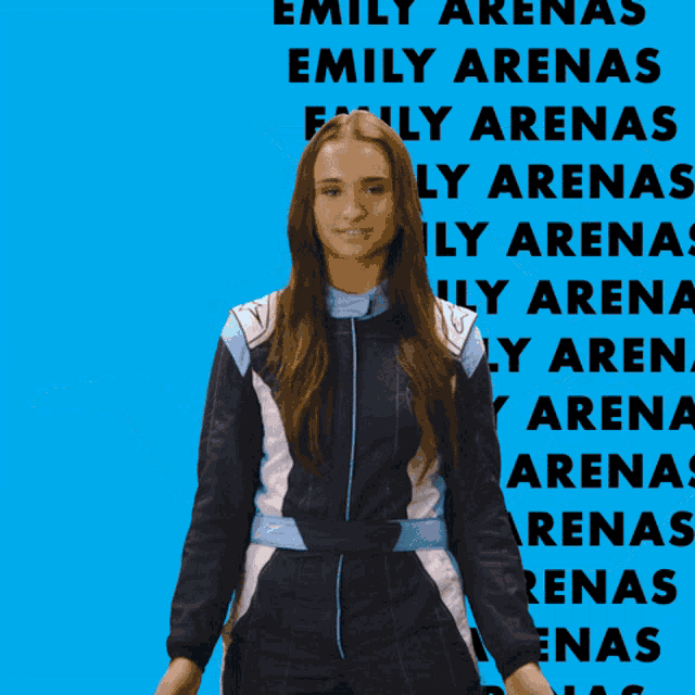 a woman in a racing suit is standing in front of a blue background with emily written on it