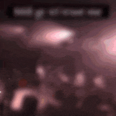 a blurred image of a woman in a pink dress with the words " i love you " in the background