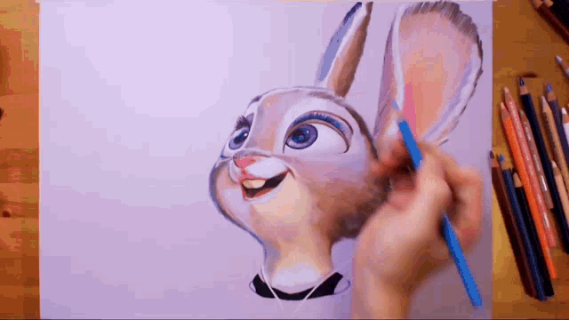 a person is drawing a bunny with a blue pencil on a piece of paper