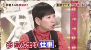 a woman in a red polka dot shirt is talking on a tv show in a foreign language .