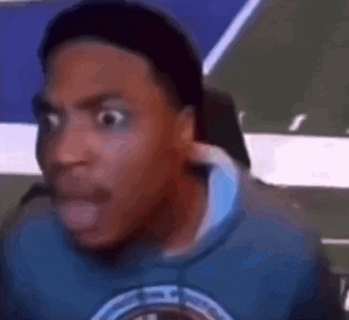 a close up of a man making a funny face while sitting in a chair .