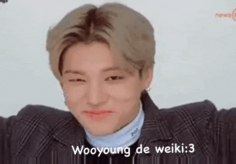 a young man is making a funny face with his eyes closed and the words wooyoung de weiki : 3 .