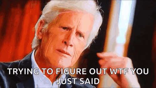 a man in a suit is making a funny face with the words trying to figure out wtf you just said below him