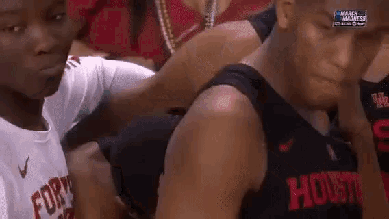 a basketball player wearing a jersey that says houston is being held by another player .