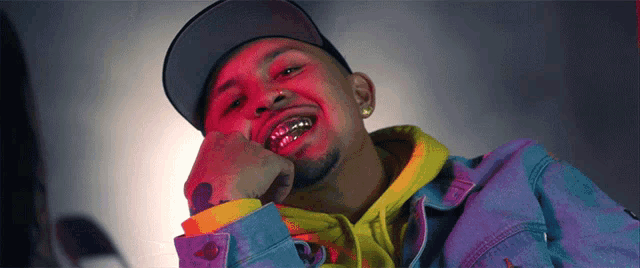 a close up of a man wearing a hat and a hoodie