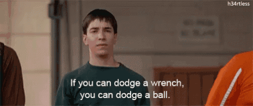 a man is standing in front of a group of people and says if you can dodge a wrench