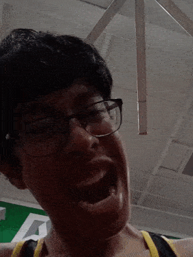 a person wearing glasses is making a funny face with their mouth open