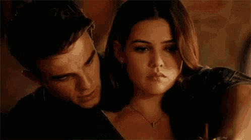 a man and a woman are hugging each other in a room .
