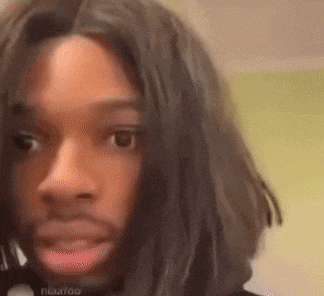 a close up of a person 's face with a wig on .