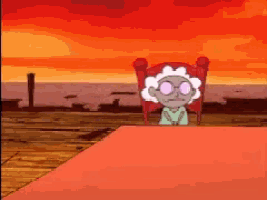 a cartoon character is sitting in a chair in front of a sunset