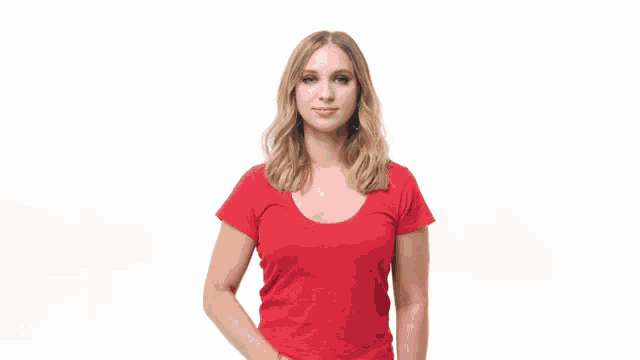 a woman in a red shirt is holding a bottle of brut