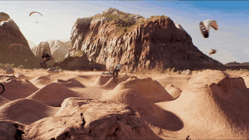 a man is riding a bike on a dirt road