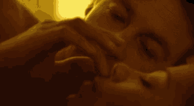 a close up of a man and woman laying down