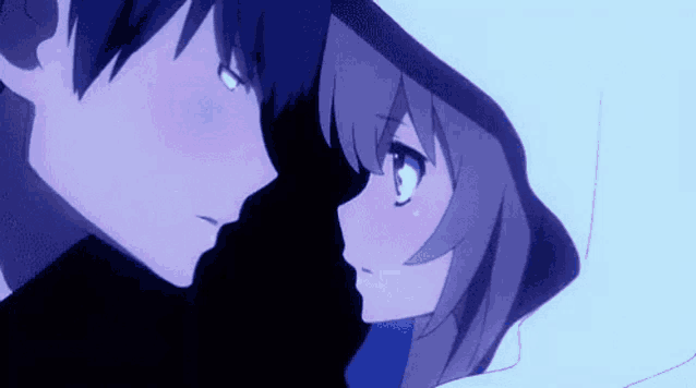 a boy and a girl are looking at each other and kissing .