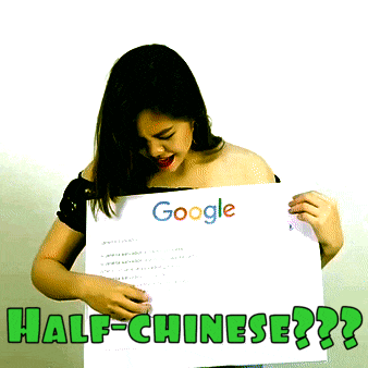 a woman is holding a sign that says google half-chinese on it