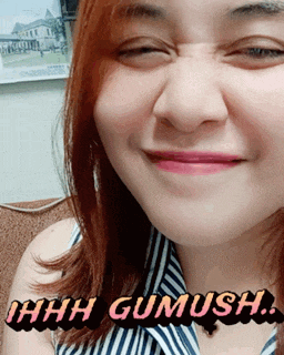 a close up of a woman 's face with the words ihhh gumusha on the bottom right