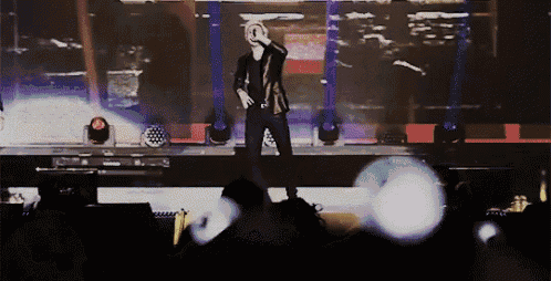 a man stands on a stage holding a microphone