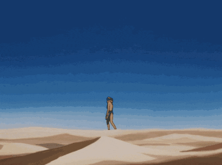 a person standing on top of a sand dune with a blue sky behind them