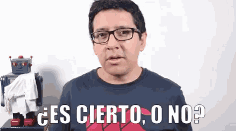 a man with glasses says " es cierto o no " in front of a robot