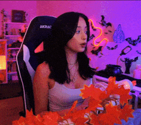 a woman sitting in an akrac chair with flowers in front of her