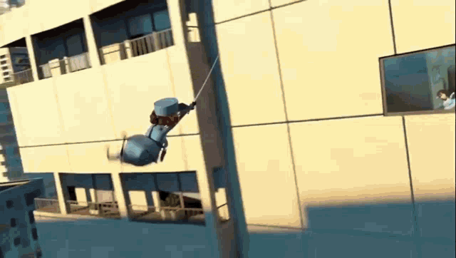 a cartoon character is hanging from a rope while flying through the air .