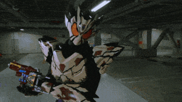 a man in a robot costume is holding a gun