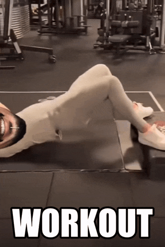 a man is laying on the floor in a gym with the word workout written on the bottom