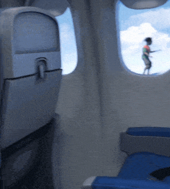 a person standing on a plane looking out of a window