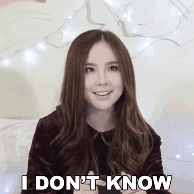 a woman says i don 't know in front of a bed