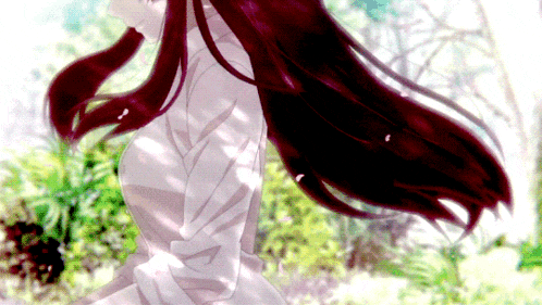 a woman with long red hair is standing in a field