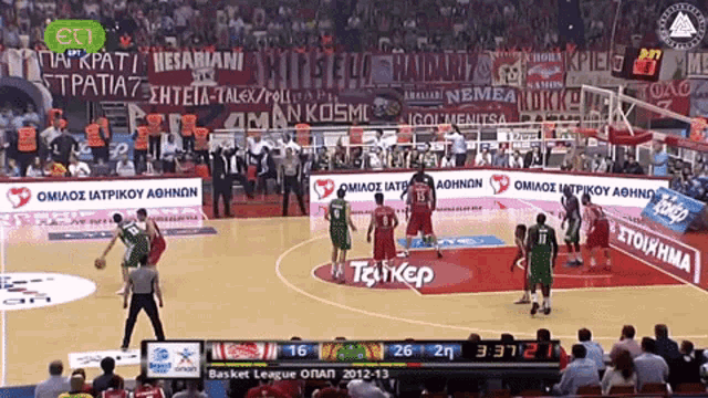 a basketball game is being played in a stadium with advertisements for taikep