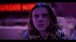 a man and a woman are sitting next to each other in front of a purple light .