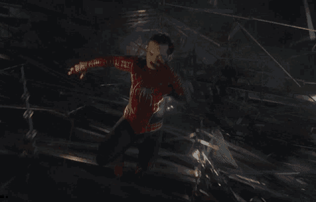 a man in a spider man costume is jumping in the air