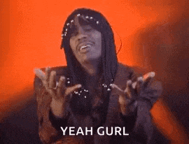 a woman is making a funny face with her hands outstretched and the words `` yeah gurl '' written below her .