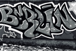 a black and white photo of graffiti on a wall with the letters b and e on it